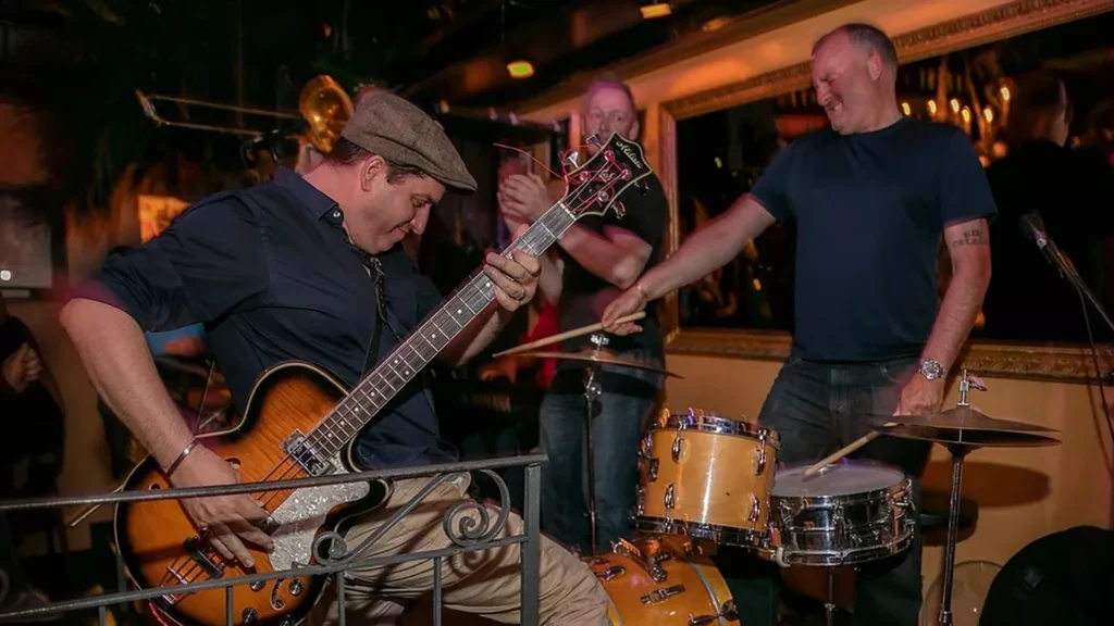 The Fallen Heroes performing live, with bass, drums and brass in a lively New Orleans rhythm and blues set.